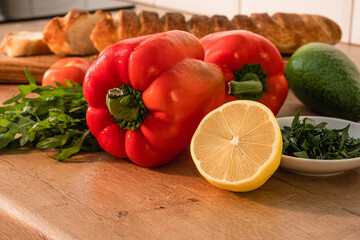  Red pepper, lemon, greens, bread and other vegetables. Healthy eating at home