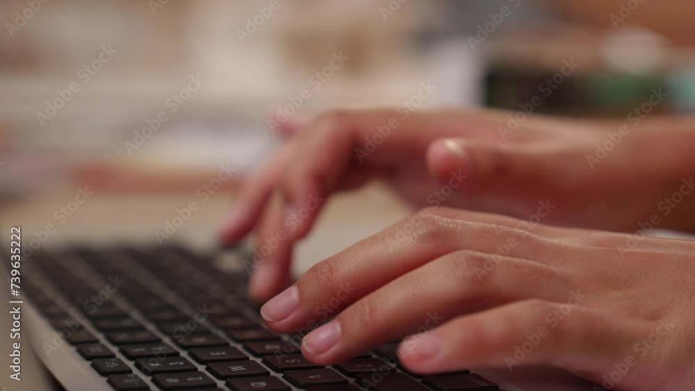 Poster slow motion closeup hand using laptop on workspace table on blurred background of colleagues or cowo