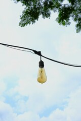 Hanging lamp with sky as background. Outdoor location. Lampu
