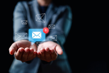 Step into the future of communication with a businessman's hand engaging an email notification icon...