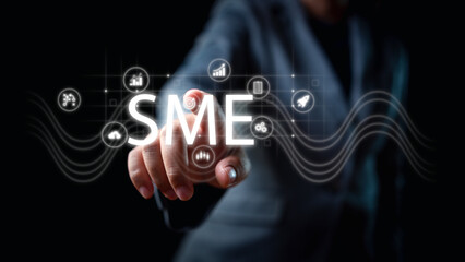 Unleash SME potential with businessman's hands touching small business icons, fueling growth and...