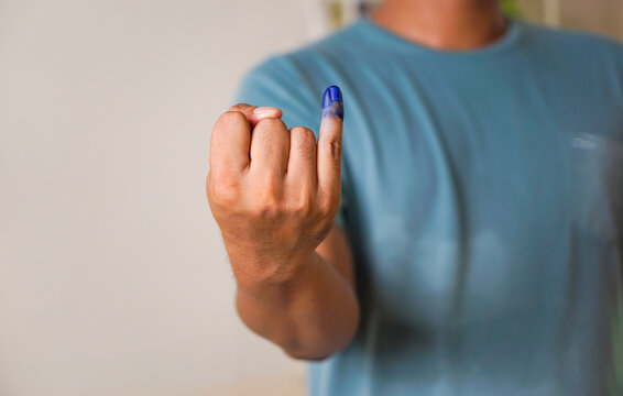 portrait of a man who shows his little finger when he has voted, concept of presidential election indonesia