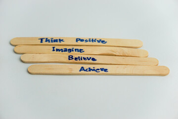 handwriting messages on ice cream sticks in close-up as a concept for building self-esteem