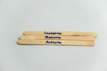 handwriting messages on ice cream sticks in close-up as a concept for building self-esteem