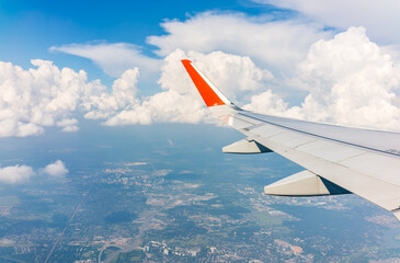Obraz premium View from the airplane window during taking off on a clear summer morning