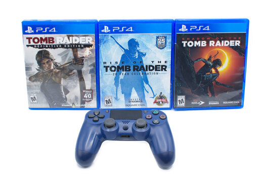 Ocala, FL 2-18-2024 Tomb Raider definitive edition, rise and shadow of the tomb raider three 3 games by crystal dynamics. Sony Playstation four 4 console with Lara Croft isolated on white background