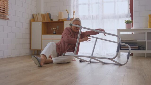 Asian senior elderly female fall on the ground while walk alone in house. 