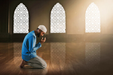 Young asian muslim man with beard praying in the mosque - 739689601