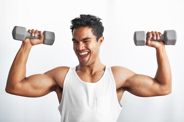 Fitness, portrait and happy man with dumbbell in studio gym for weightlifting, sports or strength...