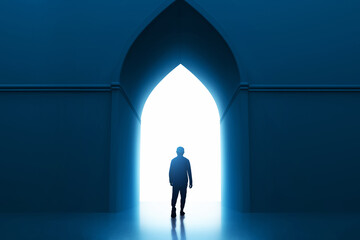 Back view shadow silhouette of young asian muslim man with beard walking alone to mosque entrance door arch at night - 739691821