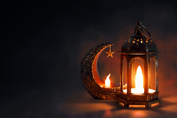 Shiny golden crescent moon with star lantern and arabic lantern on wooden floor at night, Ramadan kareem background - 739692454