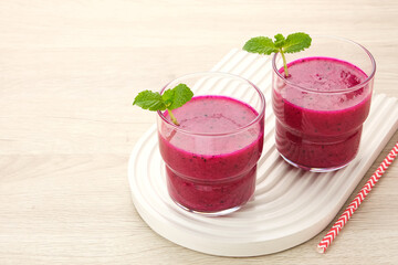 Delicious dragon fruit or pitahaya smoothie and fresh fruits with mint leaves
