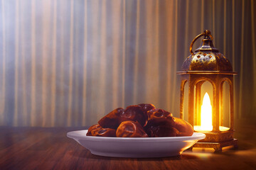 Shiny arabic lantern and bowl of fresh dried dates on wooden floor with golden curtain at night , Ramadan kareem background - 739695278