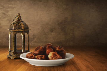 Arabic lantern and bowl of fresh dried dates on wooden floor, Ramadan kareem background - 739695473
