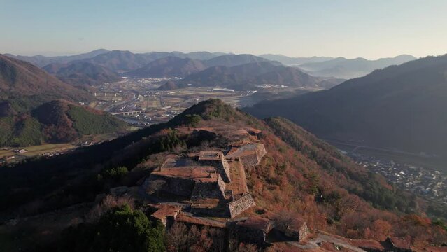 Panoramic Drone Landscape of Takeda Castle Ruins, City of Hyogo Asago Japan Sky with Sunrise light and Mountain Tops
