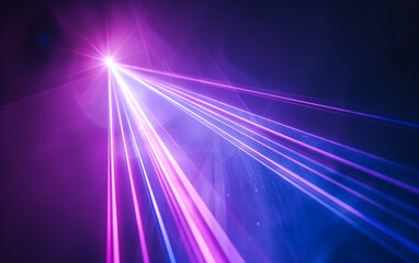 Blue and violet beams of bright laser light shining on black background