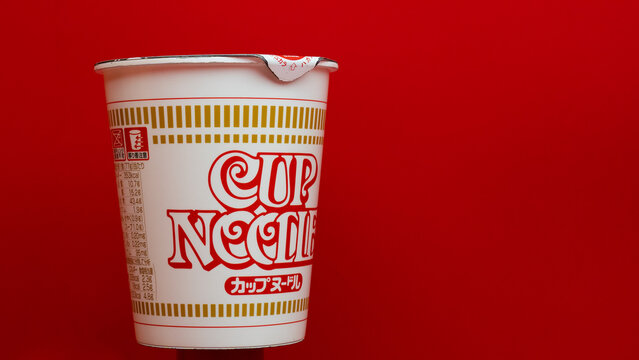 JAPAN - JAN 21, 2024: Cup Noodles container stands out with its iconic design against a bold red background, symbolizing quick, comforting meals ready in minutes in Museum, Yokohama