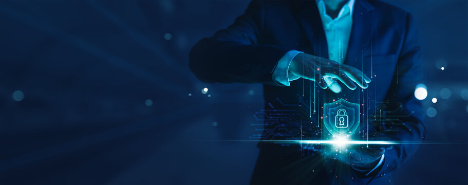 Cyber security and data protection. Businessman holding shield with padlock protecting business and financial data. Innovation technology develop smart solution from digital network attack.