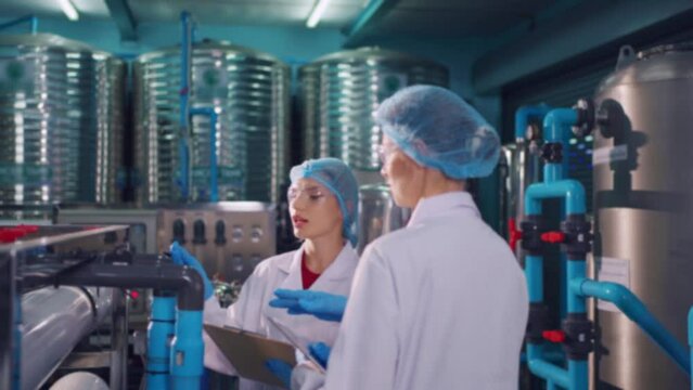 Caucasian female scientist working in laboratory at factory warehouse.