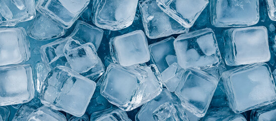 array of glistening ice cubes in various shapes and sizes fills this wide banner image. detailed textures and transparent nature of the ice cubes. cold and refreshment, marketing disign