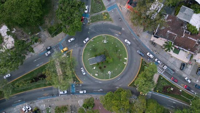 Aerial Ascending Hyperlapse of Roundabout Traffic at Ciudad Jardin. Cali, Colombia