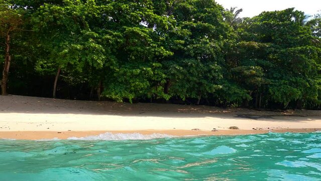 View from the turquoise sea the beautiful praia caf&eacute; with the forest at Ilheu das rolas in Sao Tome,Africa