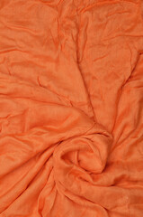 Orange crumpled textile background.