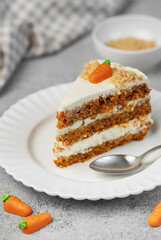Homemade carrot cake made with walnuts, iced with cream cheese. Sweet dessert.