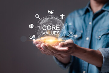 Core values responsibility ethics goals company concept. Person holding globe with core values...
