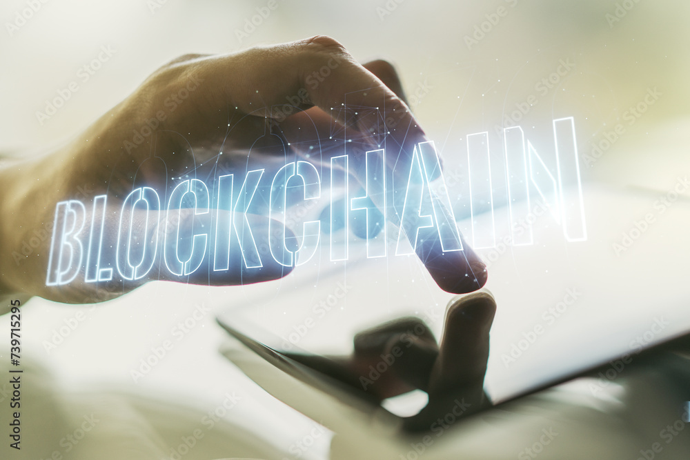 Poster double exposure of blockchain technology hologram and finger clicks on a digital tablet on backgroun