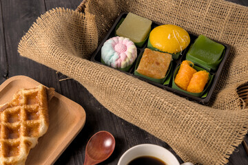 Traditional Thai dessert set in the basket on wood table.