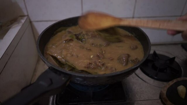 Cooking Indonesian rendang daging or beef stew originally from Minang Padang West Sumatra