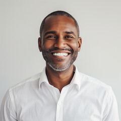 Confident Middle-Aged African American Man with a Bright Smile Wearing a White Shirt, Professional Businessman Portrait on a Light Background