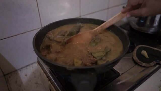 Cooking Indonesian rendang daging or beef stew originally from Minang Padang West Sumatra