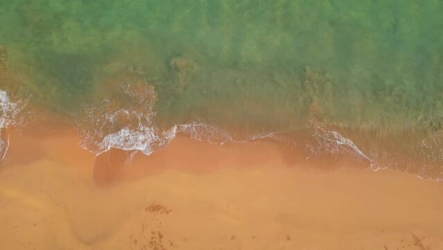 Aerial view from waves breaking generating beautiful images of the sand mixing,at Sao Tome,Africa