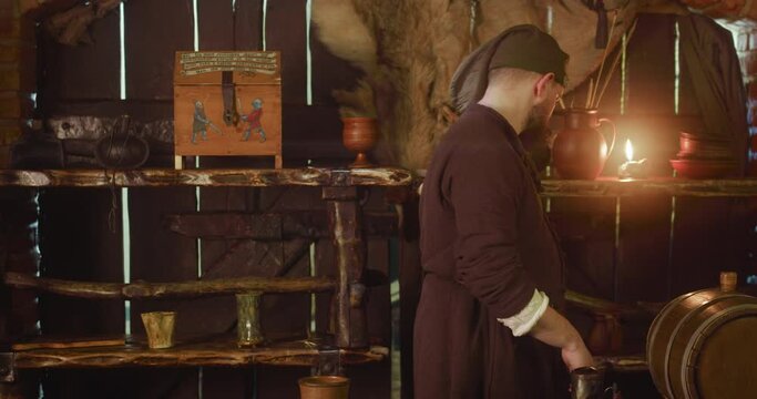 Bartender pours wine looking at unwanted guest in tavern. Displeased dwarf attendant controls visitor behavior in medieval inn. Guesthouse service