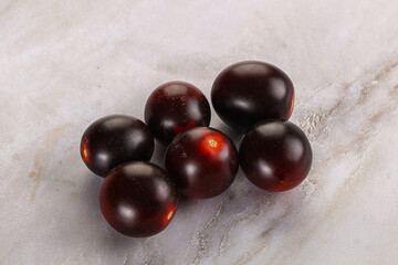 Raw ripe black kumato tomato