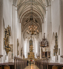 Aisle of the Århus cathedral with people standing