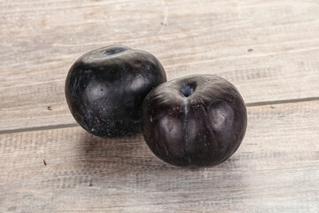 Two ripe sweet black plums