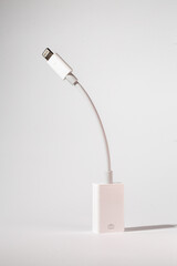 a white lightning cable is sitting on a white table