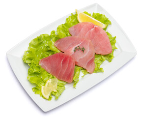 Fresh tuna Fish steak on a ceramic plate isolated on white background