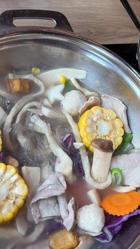 Korean foods served on a dining table. Perfect article, or any cooking contents. traditional hot pot combo, sweet garlic, and beef slices. It is very popular in sichuan