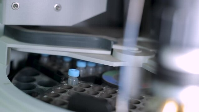 Placing a Solution Sample in Laboratory Centrifuge, Close Up