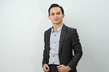 Fototapeta premium Happy confident asian indonesian business man in suit on isolated background