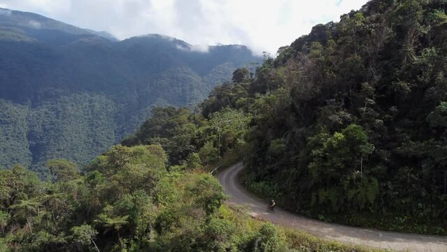 Cyclists descend world famous Yungas Road in steep mountains, Bolivia