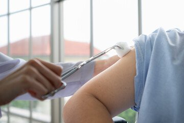 Doctor using syringe give the injection to the patient