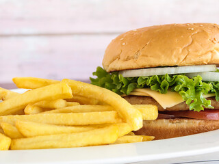CHICKEN BURGER with fries closeup served in dish isolated on table side view of appetizer fastfood