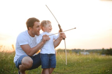 father's day. Dad and son playing together outdoors on a summer. Happy family, father, son at sunset.