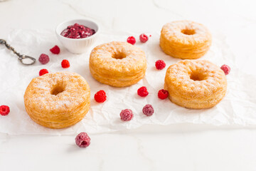 Cronuts - delicious fusion of croissant and donut with raspberry jam.
