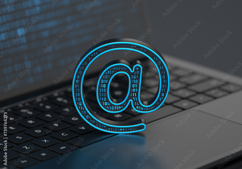 Poster a digital at-sign address icon placed on a laptop keyboard with soft depth of field on a dark backgr